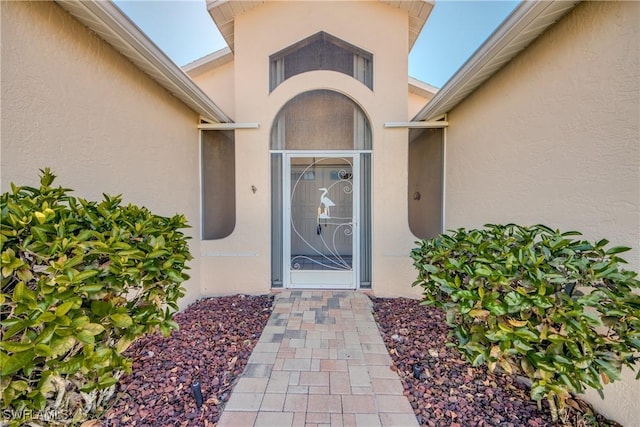 property entrance with stucco siding