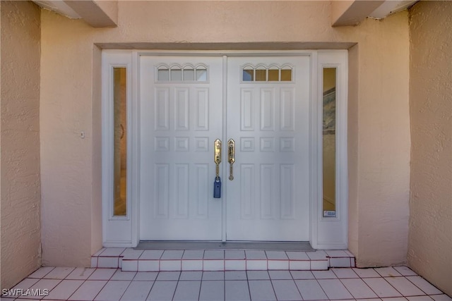 doorway to property with stucco siding