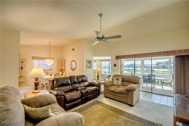 living room featuring plenty of natural light, visible vents, built in shelves, and ceiling fan