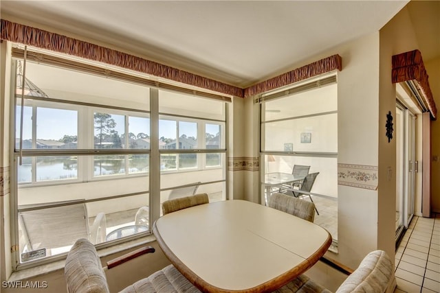 dining space with tile patterned floors and a healthy amount of sunlight