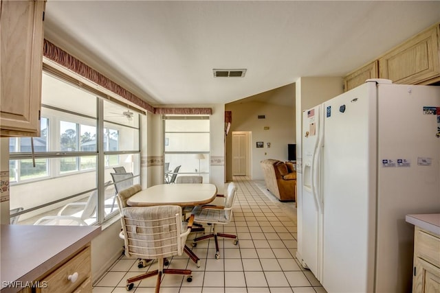 dining space with light tile patterned floors and visible vents