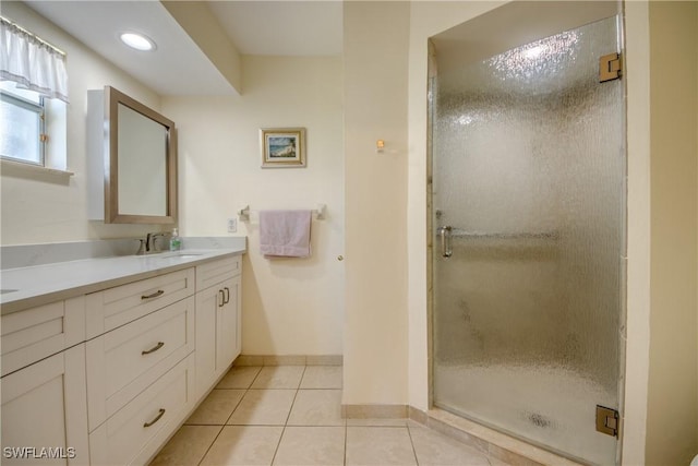 bathroom featuring vanity, recessed lighting, baseboards, a shower stall, and tile patterned floors
