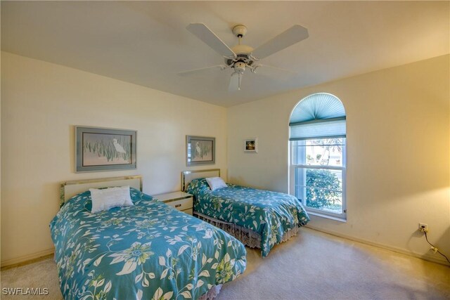carpeted bedroom with baseboards and a ceiling fan