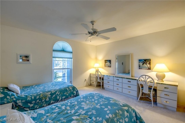 bedroom with a ceiling fan and light colored carpet
