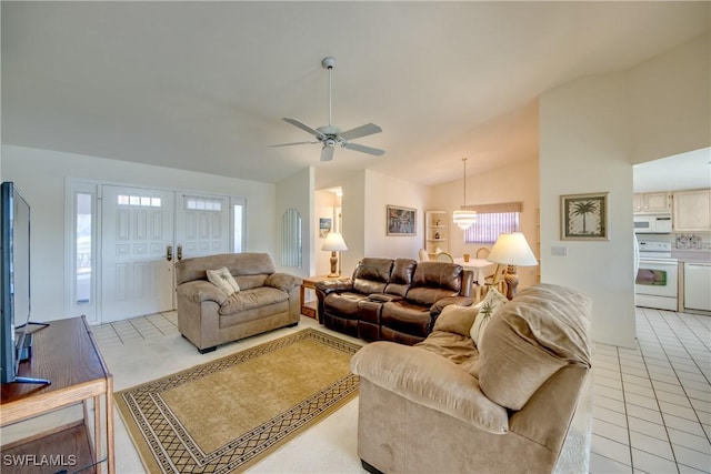 living area featuring a ceiling fan, light tile patterned floors, lofted ceiling, and a healthy amount of sunlight