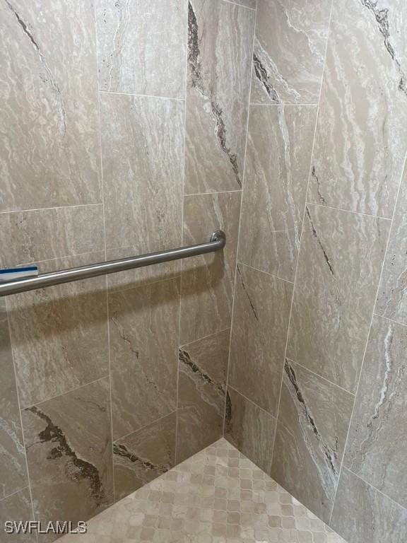 bathroom with a tile shower