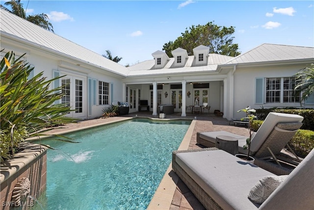505 Harbour Dr, Naples, FL 34103 - rear view of house featuring a patio area, an outdoor pool, french doors, and stucco siding