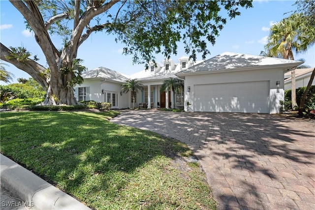 505 Harbour Dr, Naples, FL 34103 - ranch-style home featuring stucco siding, a front lawn, an attached garage, french doors, and driveway