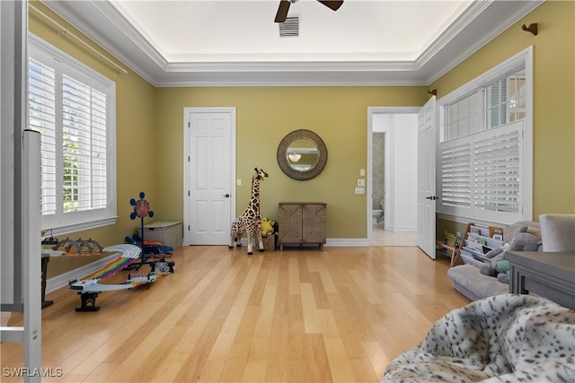 505 Harbour Dr, Naples, FL 34103 - living area with crown molding, light wood-type flooring, a ceiling fan, visible vents, and a raised ceiling