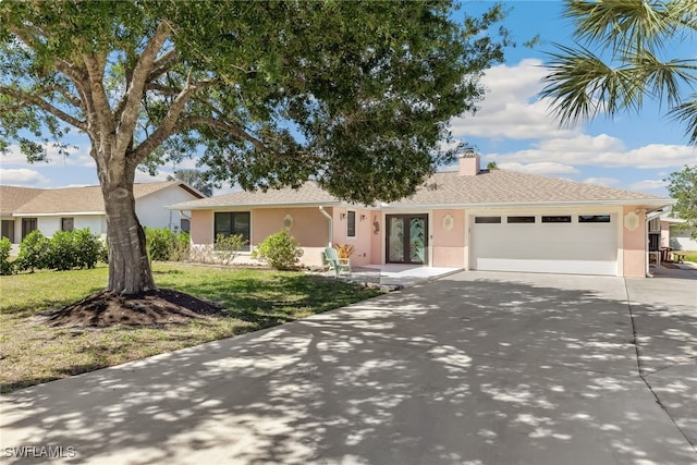 6024 Perthshire Ln, Fort Myers, FL 33908 - ranch-style home featuring stucco siding, driveway, a front yard, a garage, and a chimney