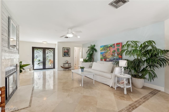6024 Perthshire Ln, Fort Myers, FL 33908 - living area featuring visible vents, baseboards, ceiling fan, french doors, and a glass covered fireplace
