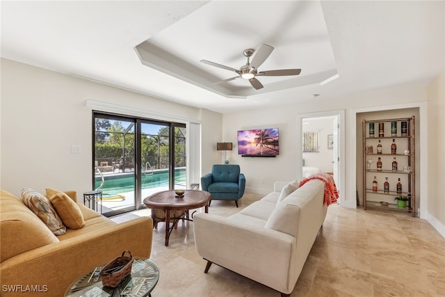 6024 Perthshire Ln, Fort Myers, FL 33908 - living area featuring baseboards, a raised ceiling, and ceiling fan
