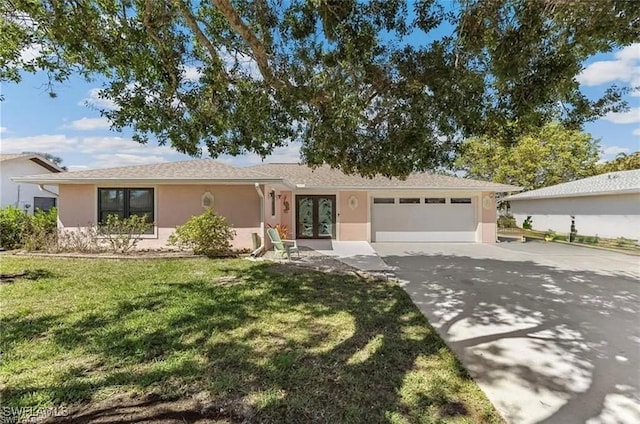6024 Perthshire Ln, Fort Myers, FL 33908 - ranch-style house with stucco siding, concrete driveway, an attached garage, and french doors