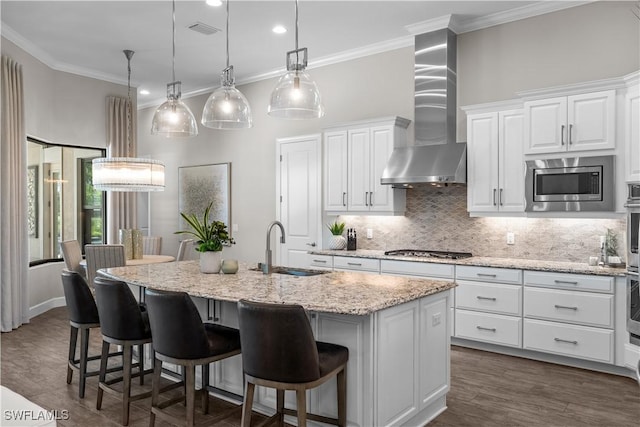 kitchen featuring a sink, wall chimney exhaust hood, stainless steel appliances, backsplash, and crown molding