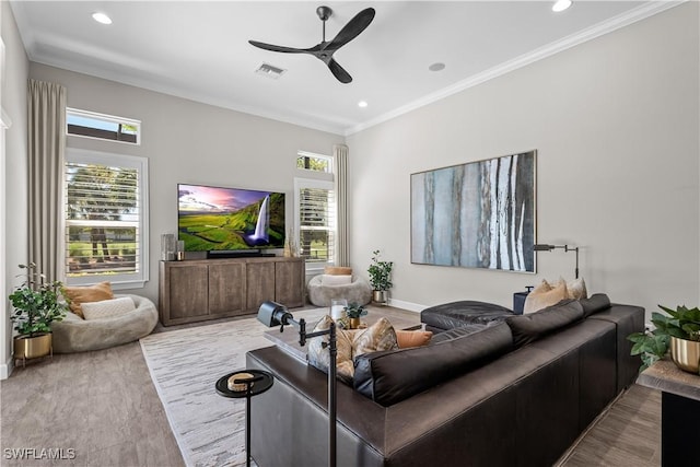 living room with a ceiling fan, healthy amount of natural light, ornamental molding, recessed lighting, and baseboards