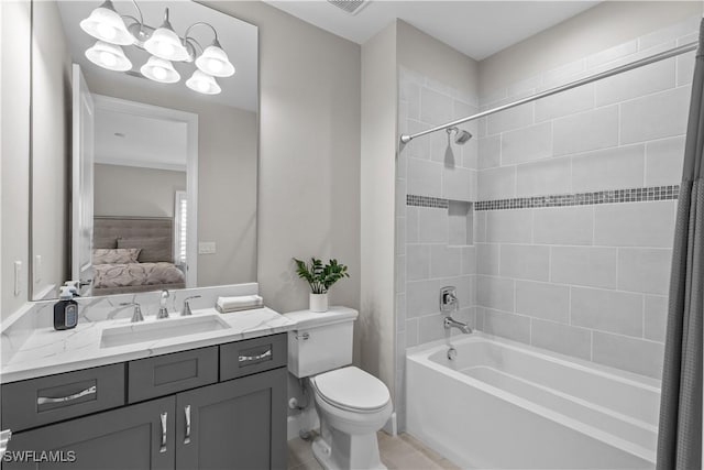 bathroom featuring ensuite bathroom, bathing tub / shower combination, toilet, vanity, and a chandelier
