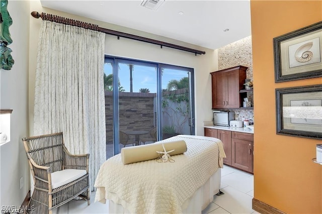 bedroom with light tile patterned floors