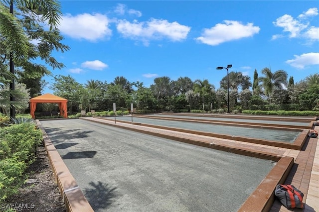 view of asphalt road with street lights and view of scattered trees
