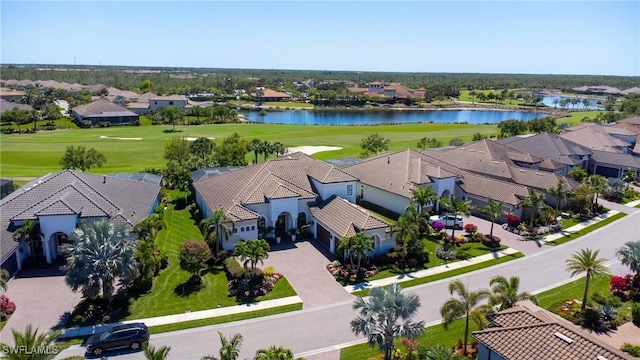 aerial perspective of suburban area featuring a golf course and a nearby body of water