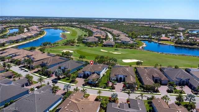 aerial overview of property's location with nearby suburban area, a local golf course, and a large body of water