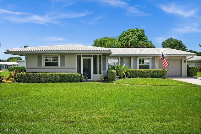 62 Lanai Cir Unit 62, Naples, FL 34112 - ranch-style house featuring a tile roof, an attached garage, concrete driveway, a front yard, and stucco siding