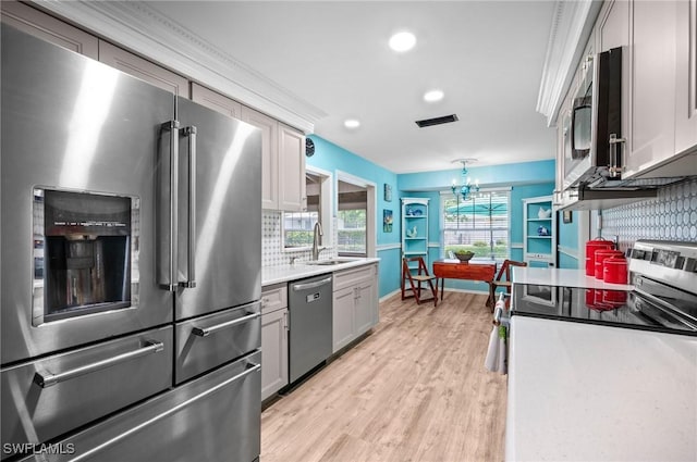 62 Lanai Cir Unit 62, Naples, FL 34112 - kitchen with stainless steel appliances, backsplash, light wood-style floors, recessed lighting, and light countertops