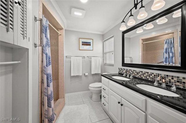 62 Lanai Cir Unit 62, Naples, FL 34112 - bathroom featuring double vanity, crown molding, a tile shower, tile patterned floors, and decorative backsplash