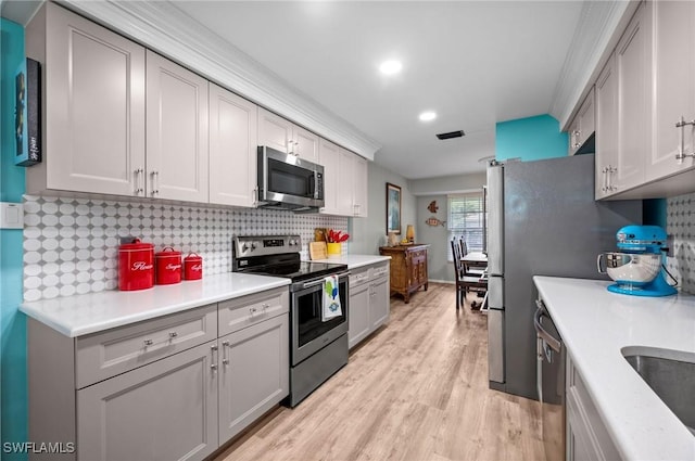 62 Lanai Cir Unit 62, Naples, FL 34112 - kitchen featuring stainless steel appliances, decorative backsplash, light wood-style flooring, light countertops, and recessed lighting