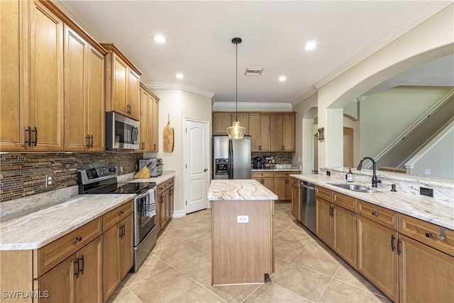 kitchen featuring a center island, light tile patterned flooring, arched walkways, appliances with stainless steel finishes, and brown cabinetry