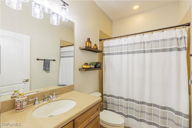 bathroom with toilet, vanity, and a shower with shower curtain