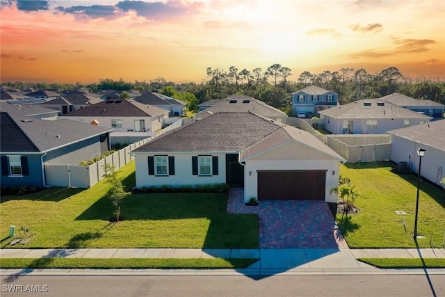 6667 Estero Bay Dr, Fort Myers, FL 33908 - view of front of home featuring a residential view, decorative driveway, stucco siding, and a lawn