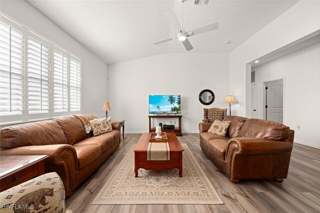 6667 Estero Bay Dr, Fort Myers, FL 33908 - living room featuring wood finished floors, lofted ceiling, baseboards, visible vents, and ceiling fan