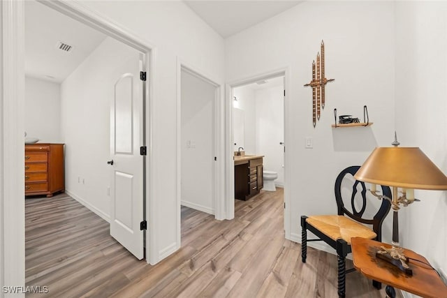 6667 Estero Bay Dr, Fort Myers, FL 33908 - hallway featuring baseboards, visible vents, and light wood-style floors