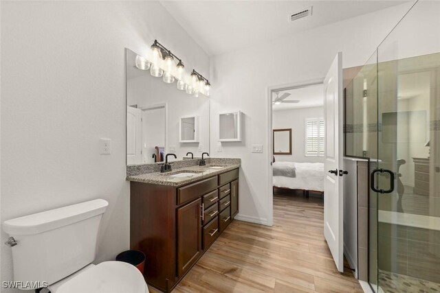 6667 Estero Bay Dr, Fort Myers, FL 33908 - bathroom with double vanity, a sink, toilet, and wood finished floors