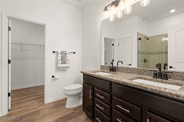 6667 Estero Bay Dr, Fort Myers, FL 33908 - bathroom featuring wood finished floors, a sink, double vanity, and a shower stall