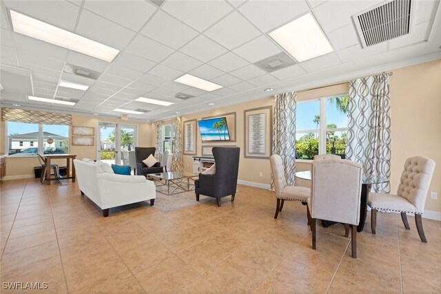 6667 Estero Bay Dr, Fort Myers, FL 33908 - living area with baseboards, visible vents, light tile patterned floors, and a paneled ceiling