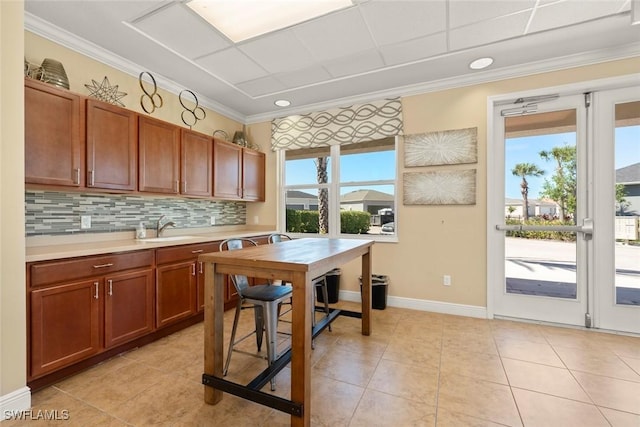 6667 Estero Bay Dr, Fort Myers, FL 33908 - kitchen with light countertops, tasteful backsplash, ornamental molding, and a healthy amount of sunlight