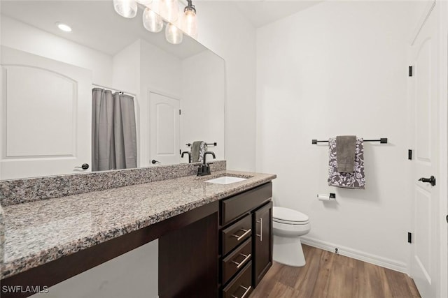 6667 Estero Bay Dr, Fort Myers, FL 33908 - bathroom featuring toilet, wood finished floors, baseboards, and vanity