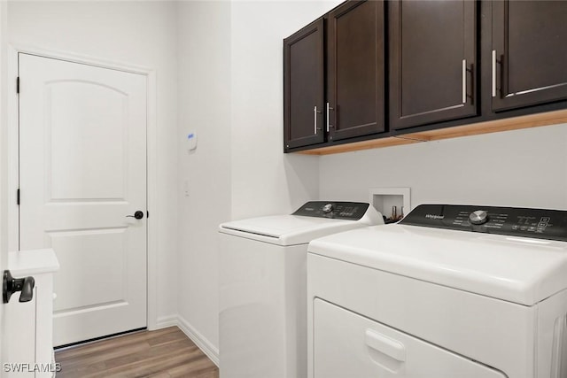 6667 Estero Bay Dr, Fort Myers, FL 33908 - laundry room with cabinet space, baseboards, light wood-style floors, and separate washer and dryer