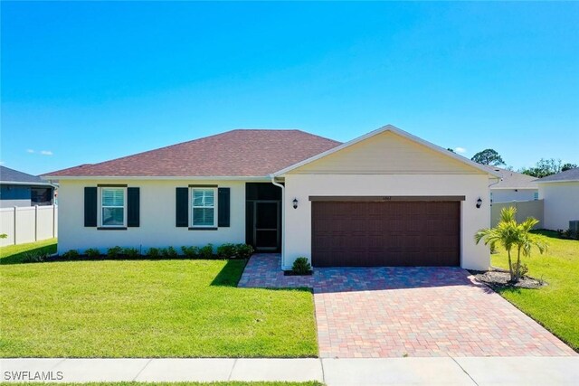 6667 Estero Bay Dr, Fort Myers, FL 33908 - ranch-style home featuring decorative driveway, stucco siding, fence, and a front lawn