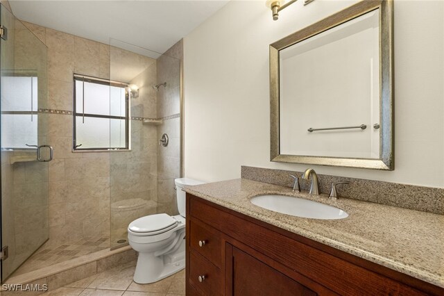920 SW 4th Pl, Cape Coral, FL 33991 - full bath featuring vanity, toilet, a stall shower, and tile patterned flooring
