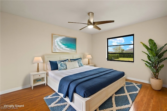 920 SW 4th Pl, Cape Coral, FL 33991 - bedroom with a ceiling fan, wood finished floors, and baseboards