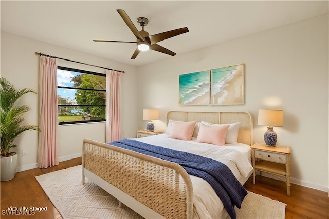 920 SW 4th Pl, Cape Coral, FL 33991 - bedroom with baseboards, wood finished floors, and a ceiling fan