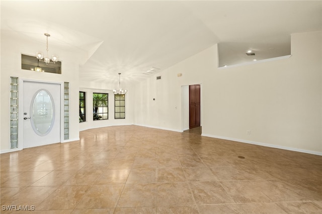 920 SW 4th Pl, Cape Coral, FL 33991 - foyer featuring high vaulted ceiling, light tile patterned floors, baseboards, and a chandelier