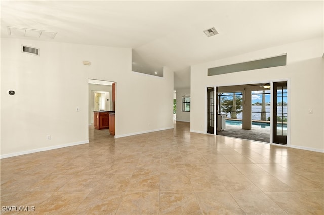 920 SW 4th Pl, Cape Coral, FL 33991 - empty room featuring visible vents, baseboards, and high vaulted ceiling