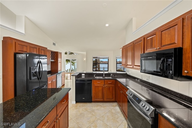 920 SW 4th Pl, Cape Coral, FL 33991 - kitchen with black appliances, a sink, dark stone countertops, light tile patterned floors, and vaulted ceiling
