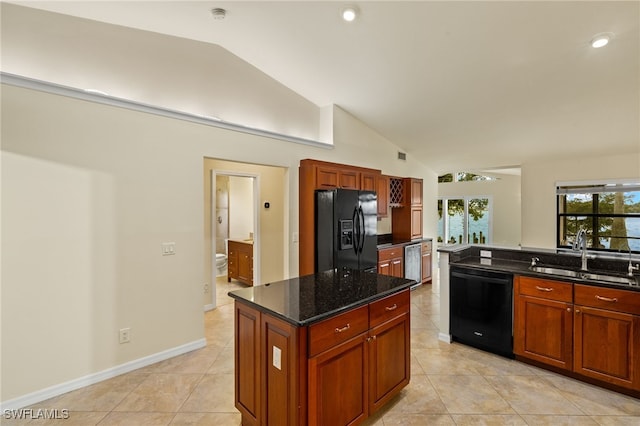 920 SW 4th Pl, Cape Coral, FL 33991 - kitchen featuring black appliances, light tile patterned flooring, dark stone countertops, and a sink