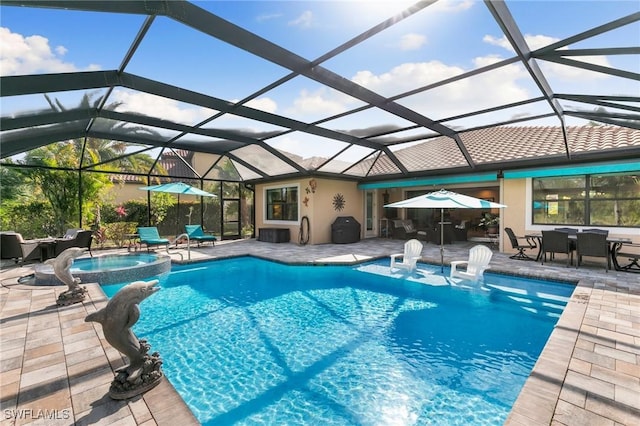 1621 Songbird Ct, Naples, FL 34120 - view of swimming pool featuring a patio area, outdoor dining area, glass enclosure, and a pool with connected hot tub