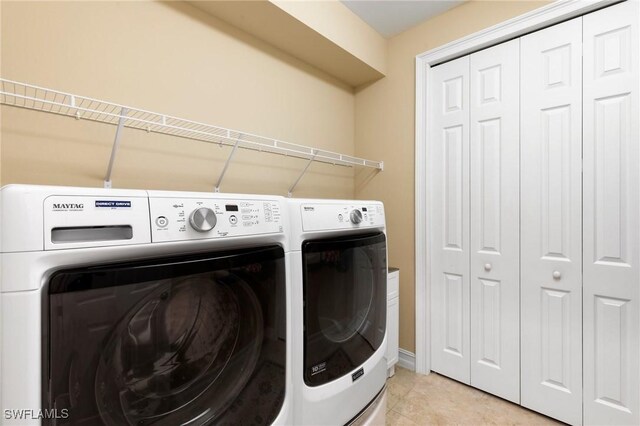 1621 Songbird Ct, Naples, FL 34120 - laundry area with washer and clothes dryer and light tile patterned flooring
