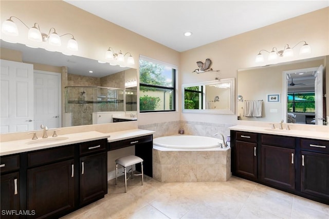 1621 Songbird Ct, Naples, FL 34120 - full bath featuring two vanities, a tile shower, a bath, tile patterned flooring, and a ceiling fan